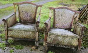 Rotting armchairs in street